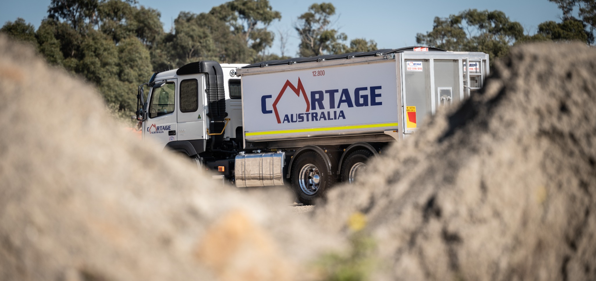 Cartage Australia truck operating among quarry material stockpiles